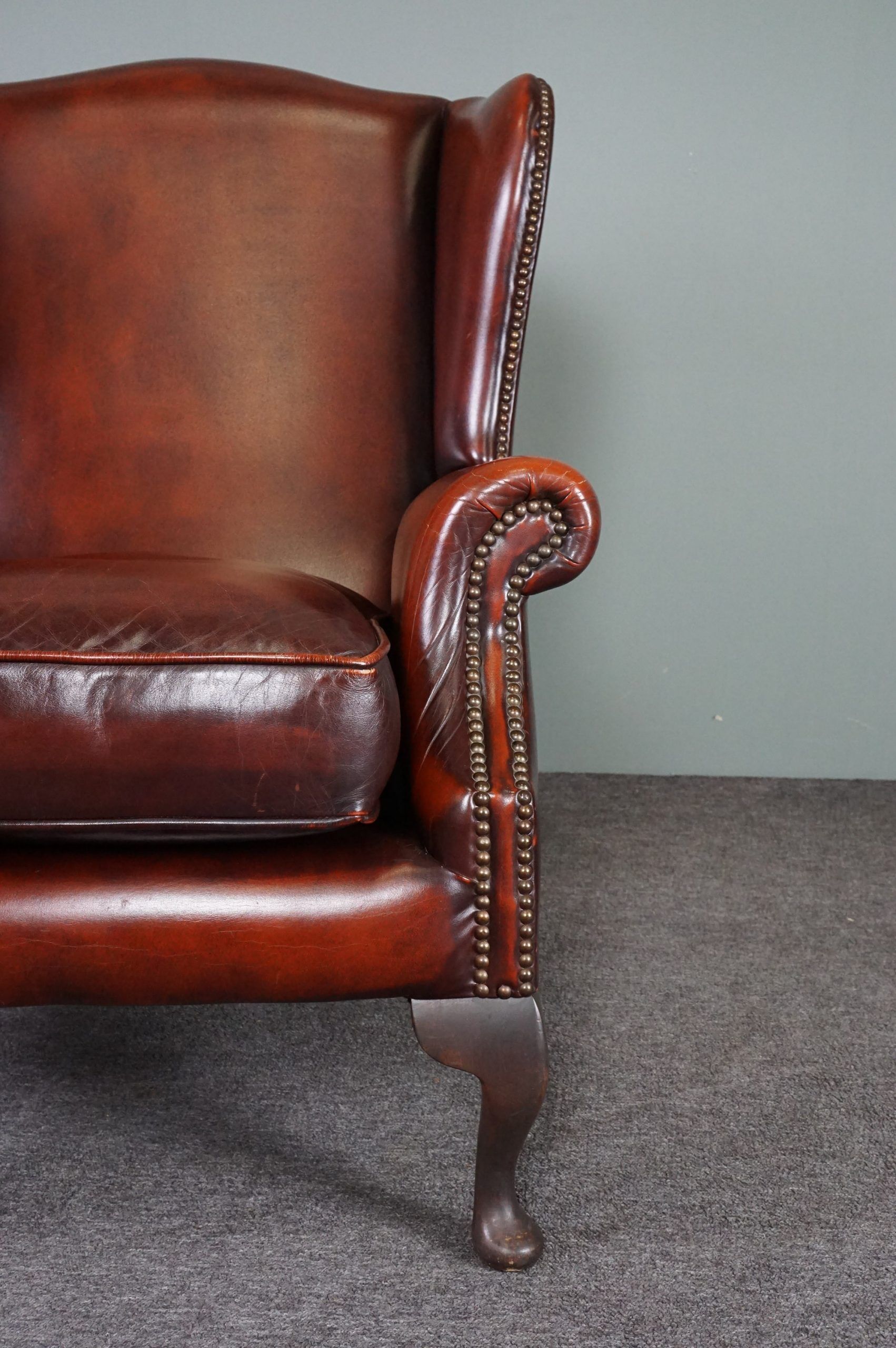 Leather armchair with decorative nails