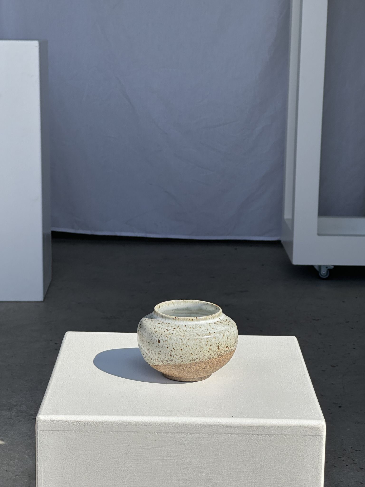 Small white ball vase tight neck in glazed speckled ceramic