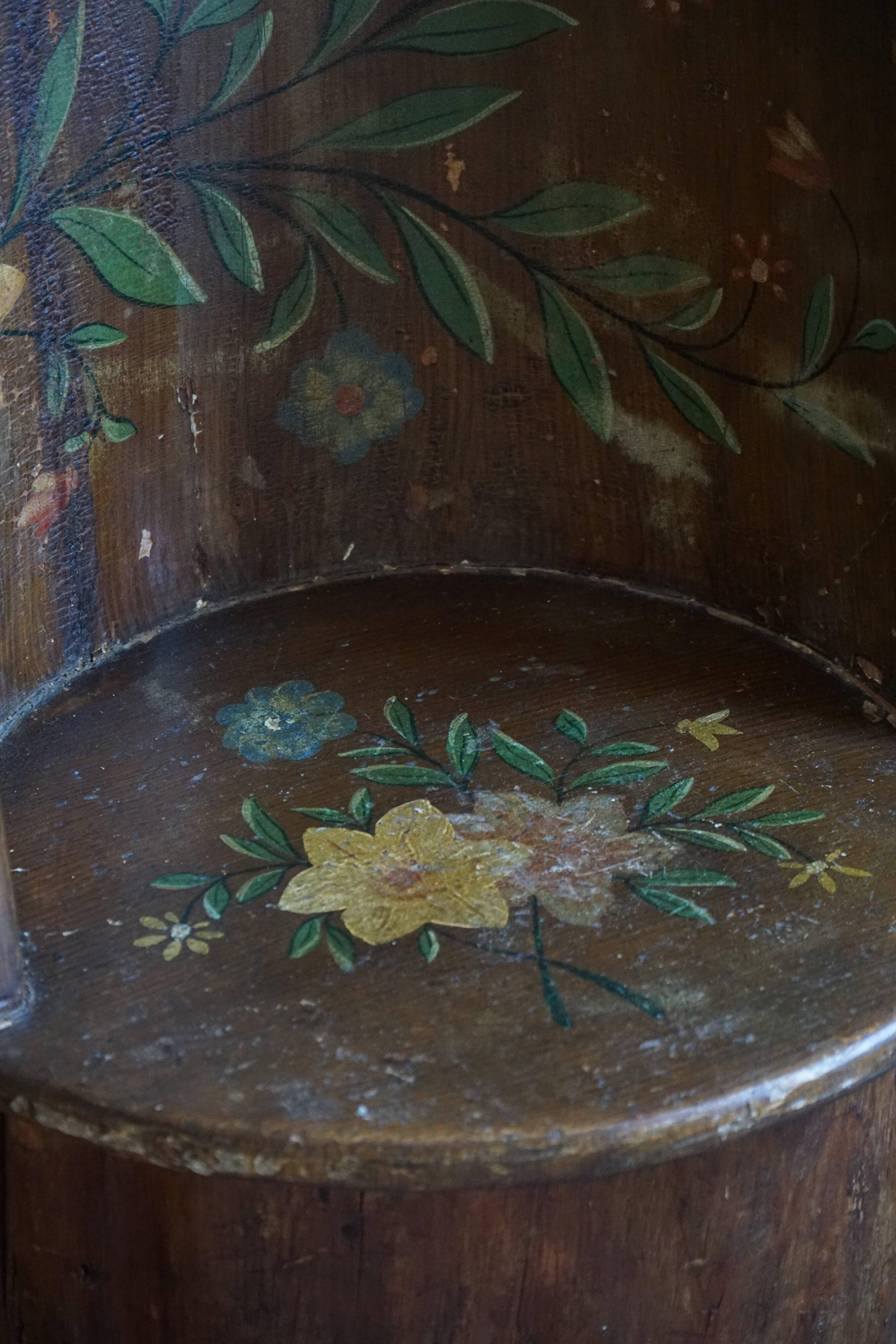 Pair of Swedish folk art stump chairs, decorated with painted floral motifs, late 19th century.