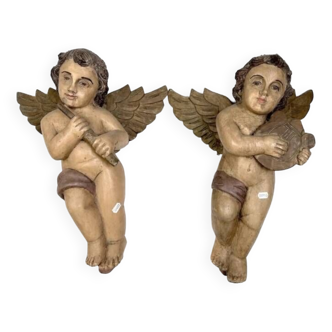 Pair of musical cherubs in polychrome carved wood