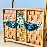 Vintage rattan magazine holder with floral decoration
