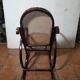 Curved wooden rocking chair with caning
