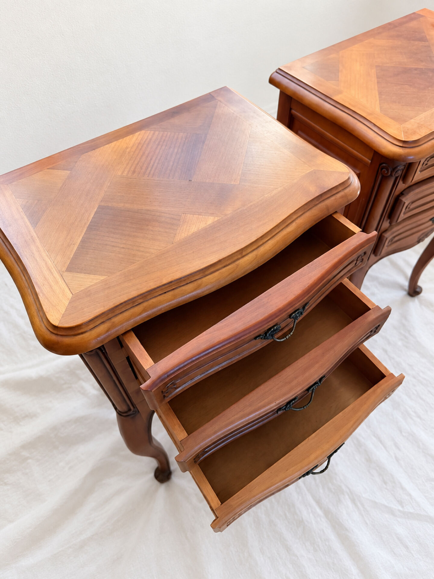 Pair of cherry wood bedside tables in Louis XV style with 3 drawers.