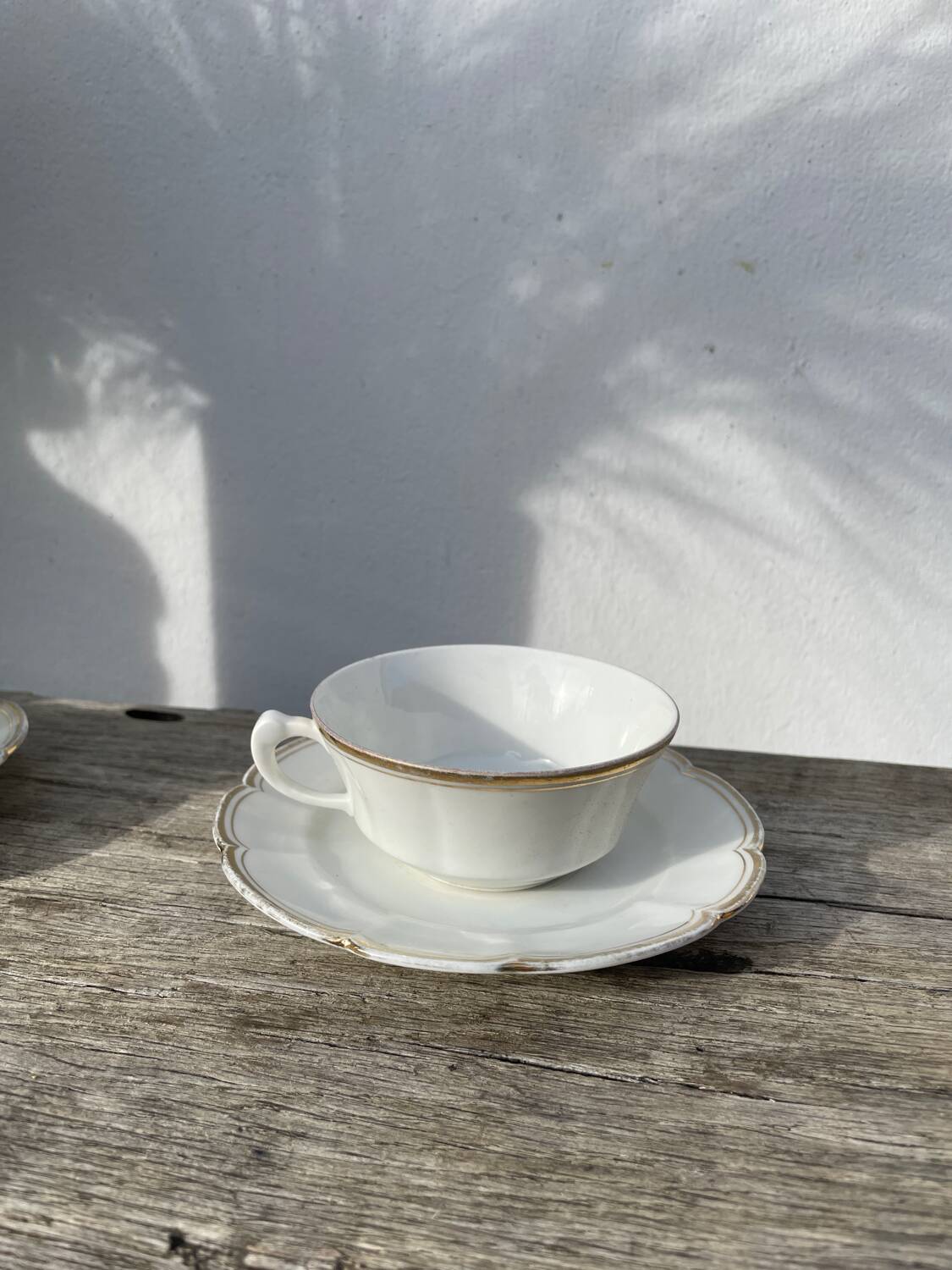 Pair of fine white and gold Limoges porcelain teacups