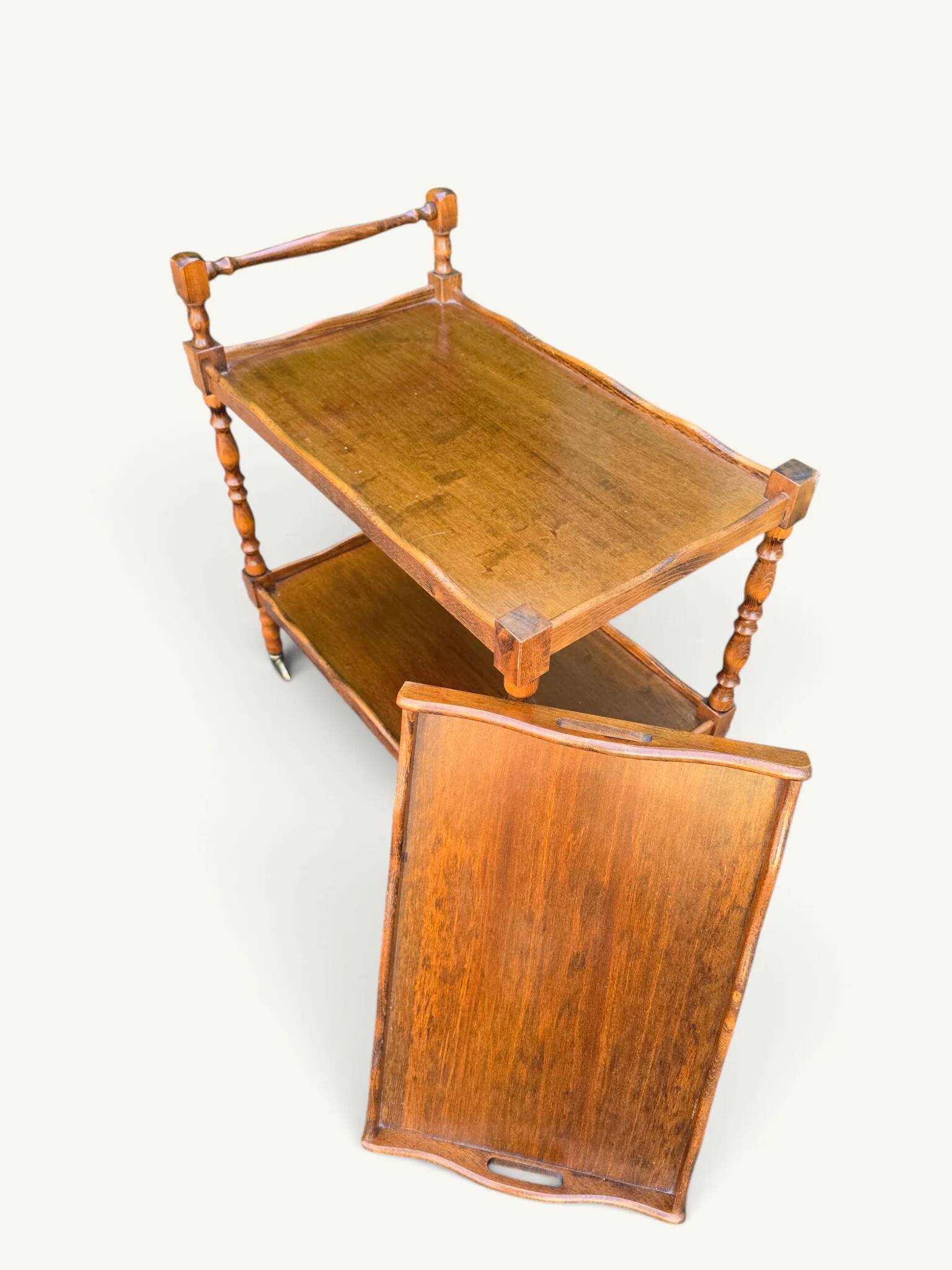 Vintage wooden turned rolling dessert trolley, removable tray.
