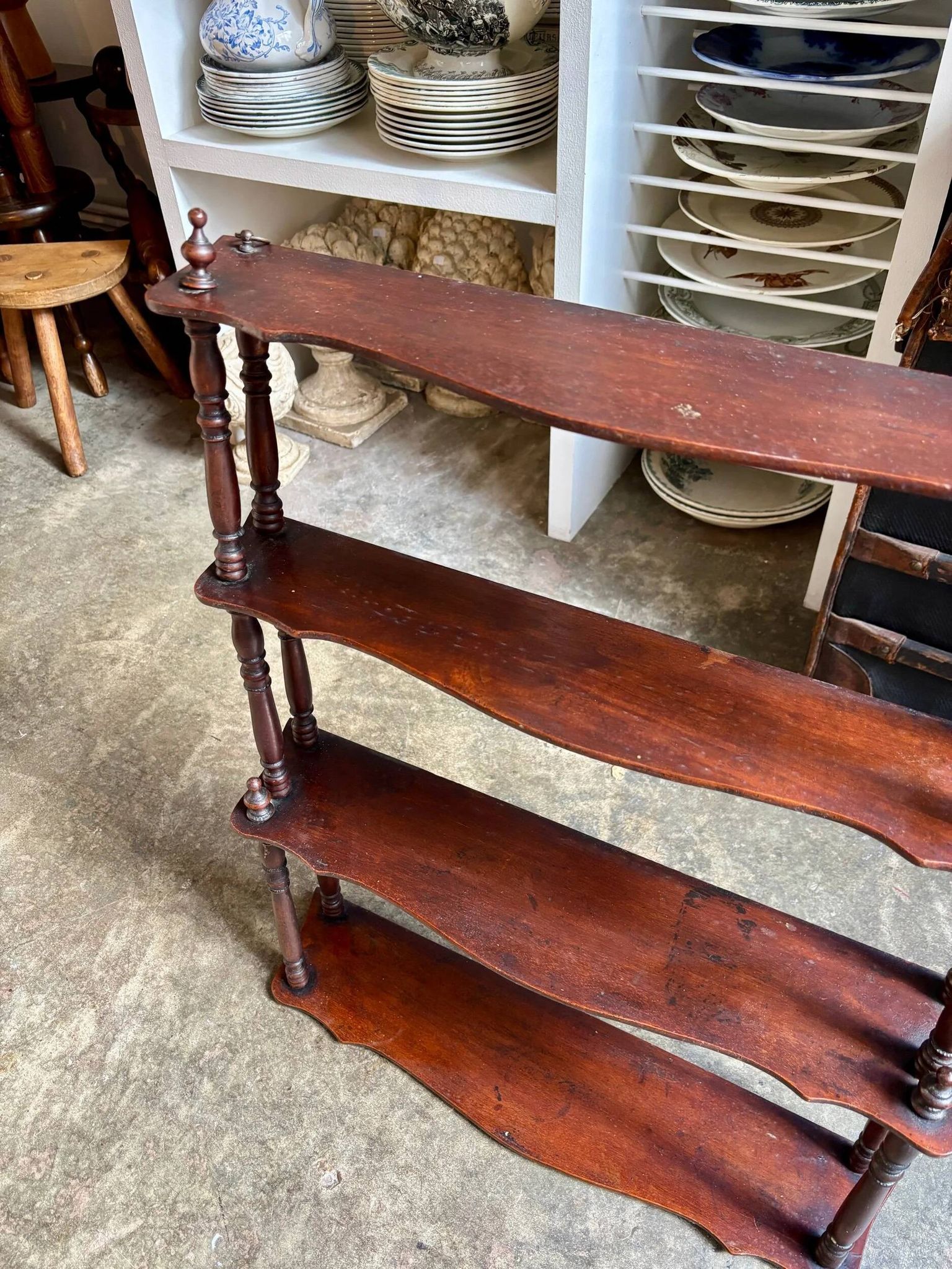 Curved and turned wooden wall shelf