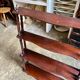 Curved and turned wooden wall shelf