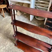 Curved and turned wooden wall shelf