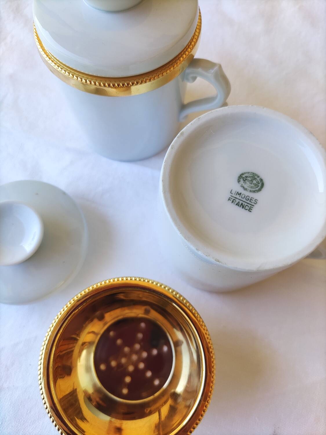 2 white and gold Limoges porcelain tea cups