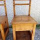 2 old wooden children's chairs with a small chest.