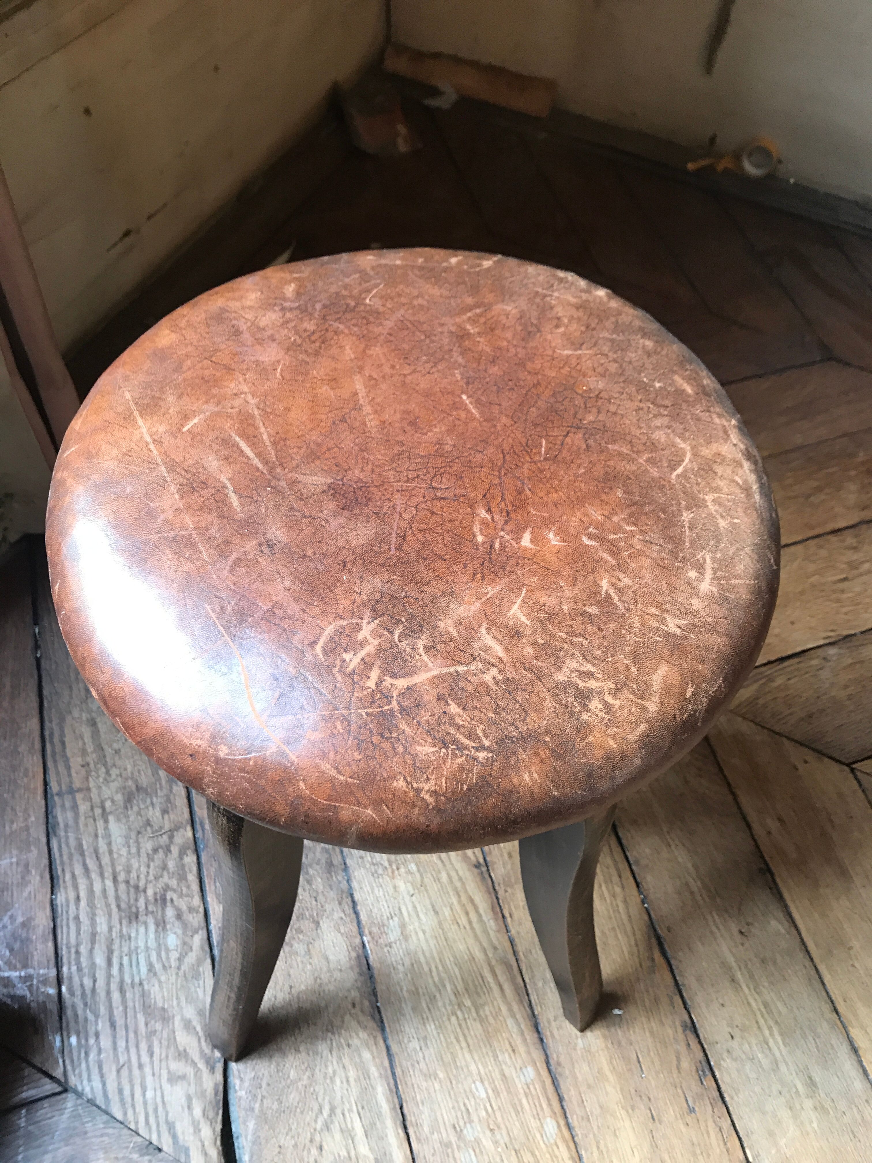 Old leather rotating piano stool