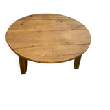 Large round antique coffee table made of raw solid wood.