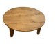 Large round antique coffee table made of raw solid wood.