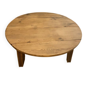 Large round antique coffee table made of raw solid wood.