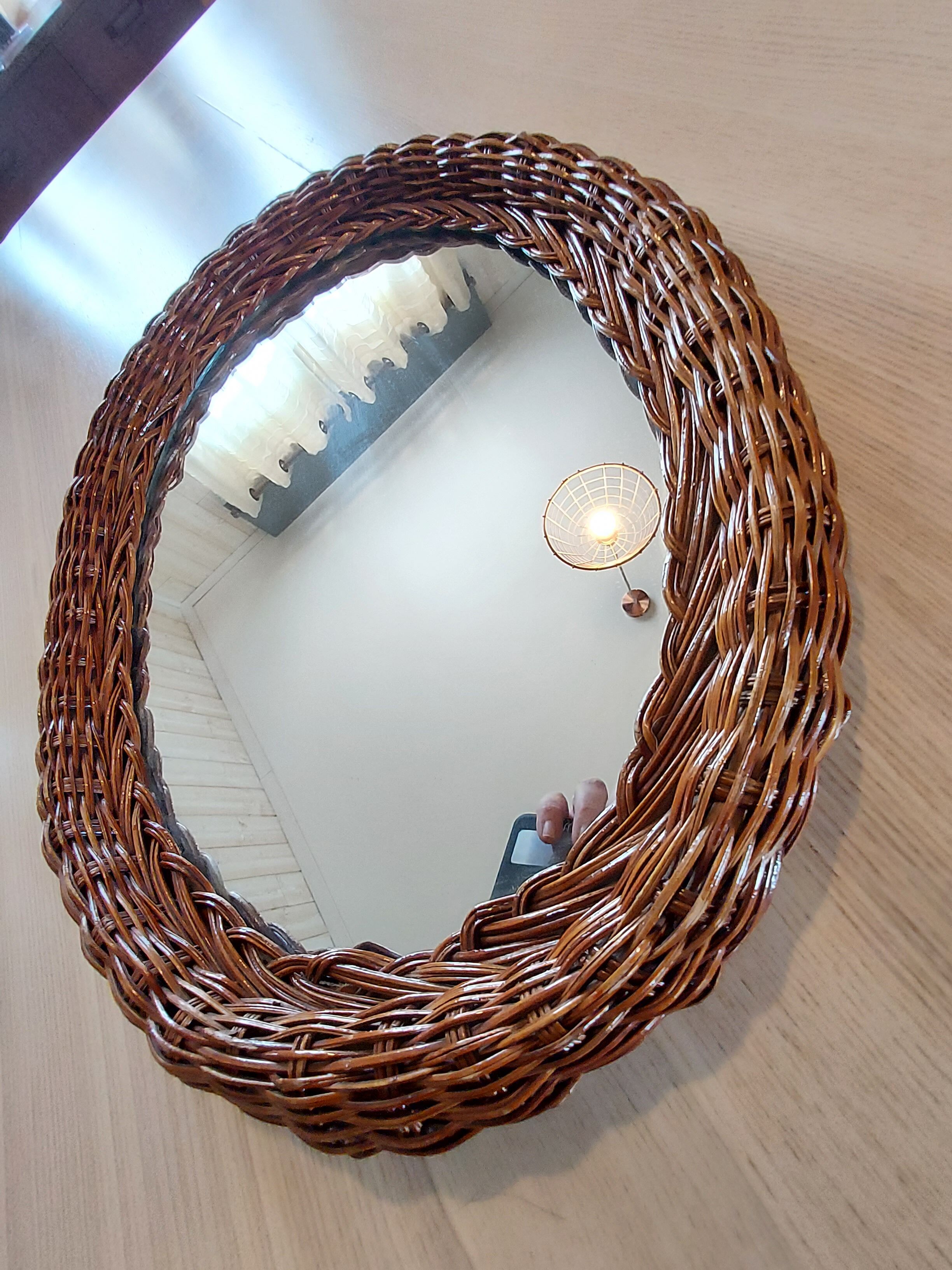 Oval mirror in dark rattan