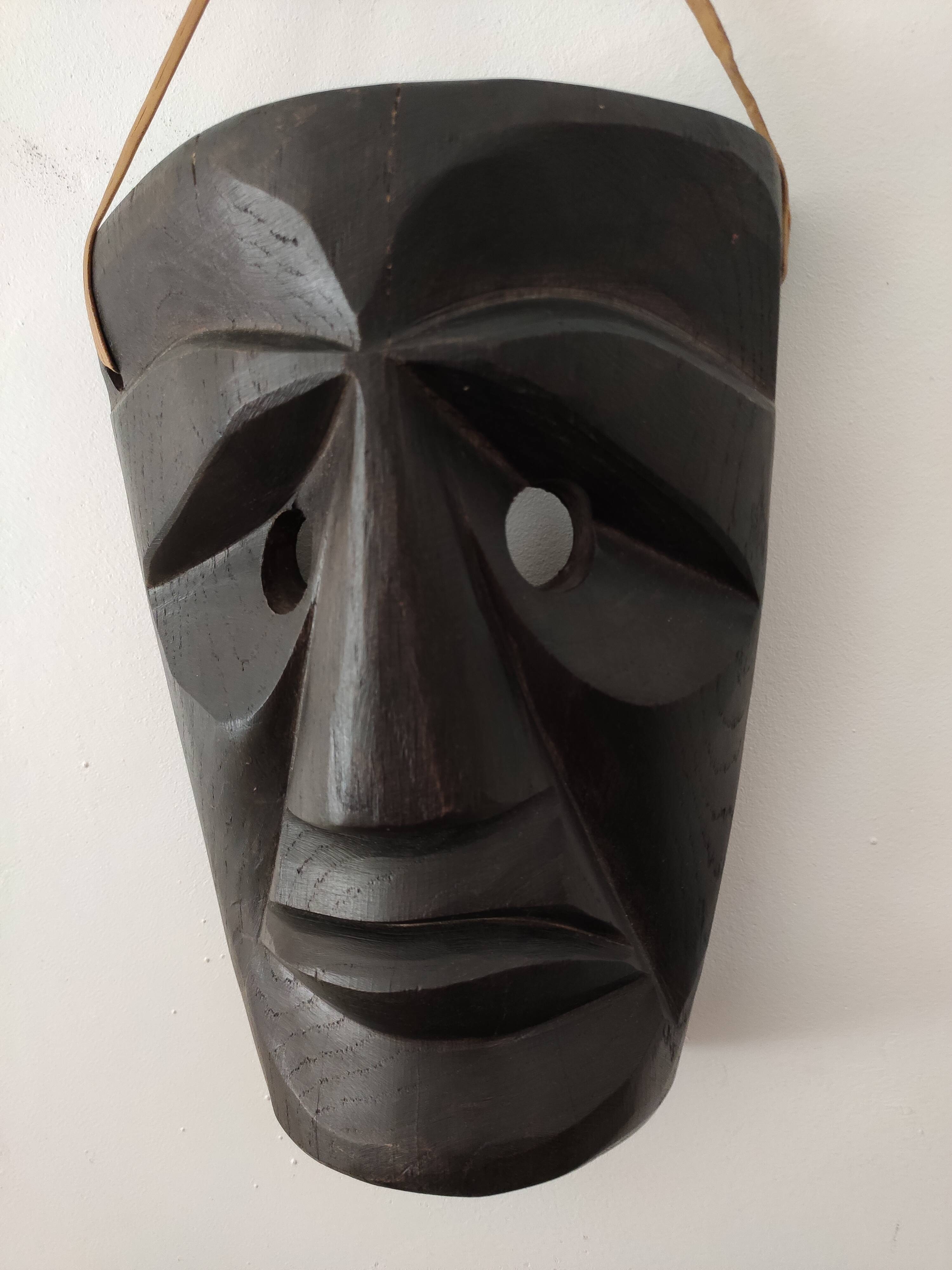 Ethnic ebony wood mask for display or hanging.