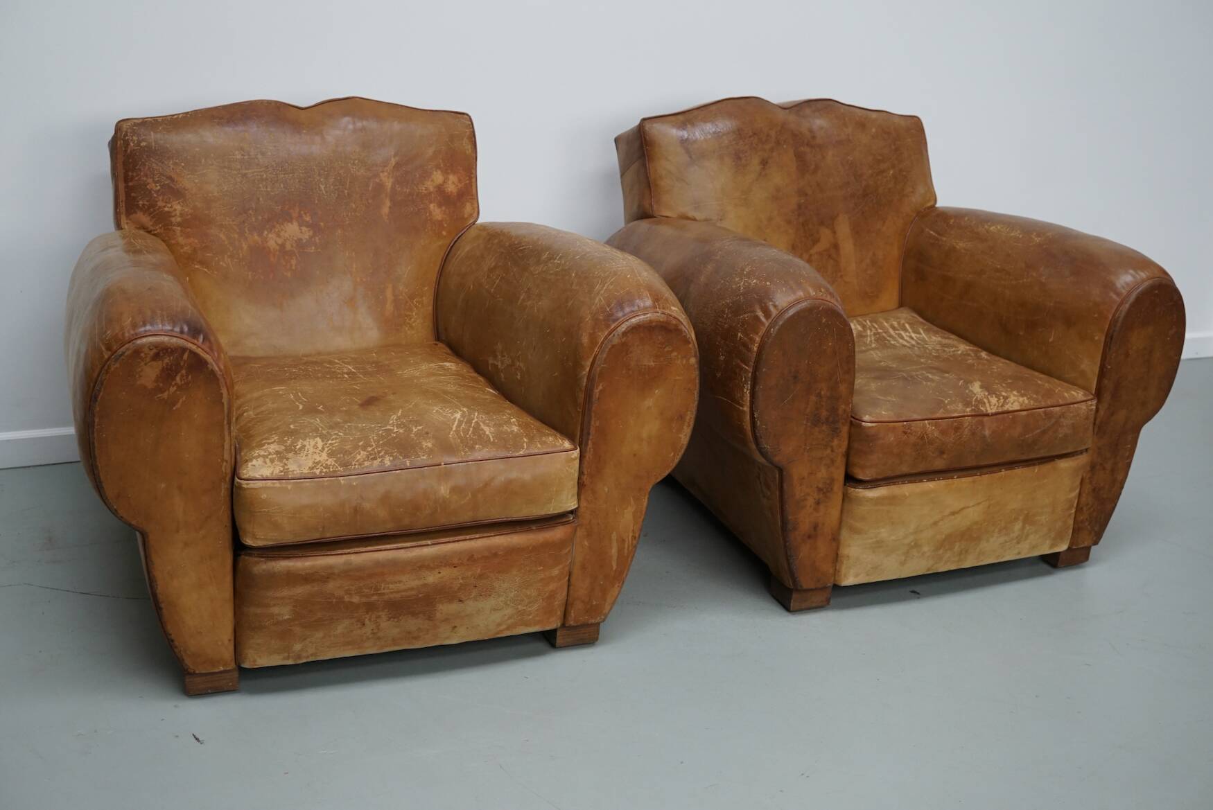 Pair of French club chairs with moustache back in cognac leather, 1940s