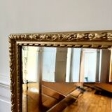 Bevelled mirror in carved gilded wood