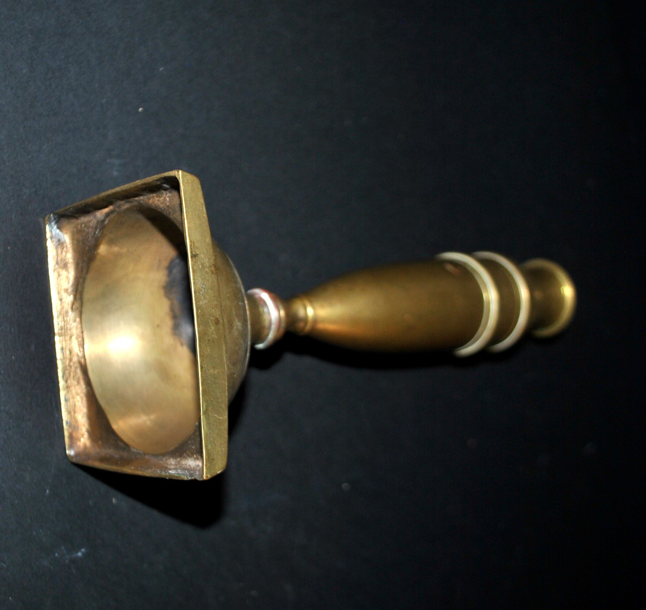 Antique baluster candlestick in bronze with hand-chiseled design.