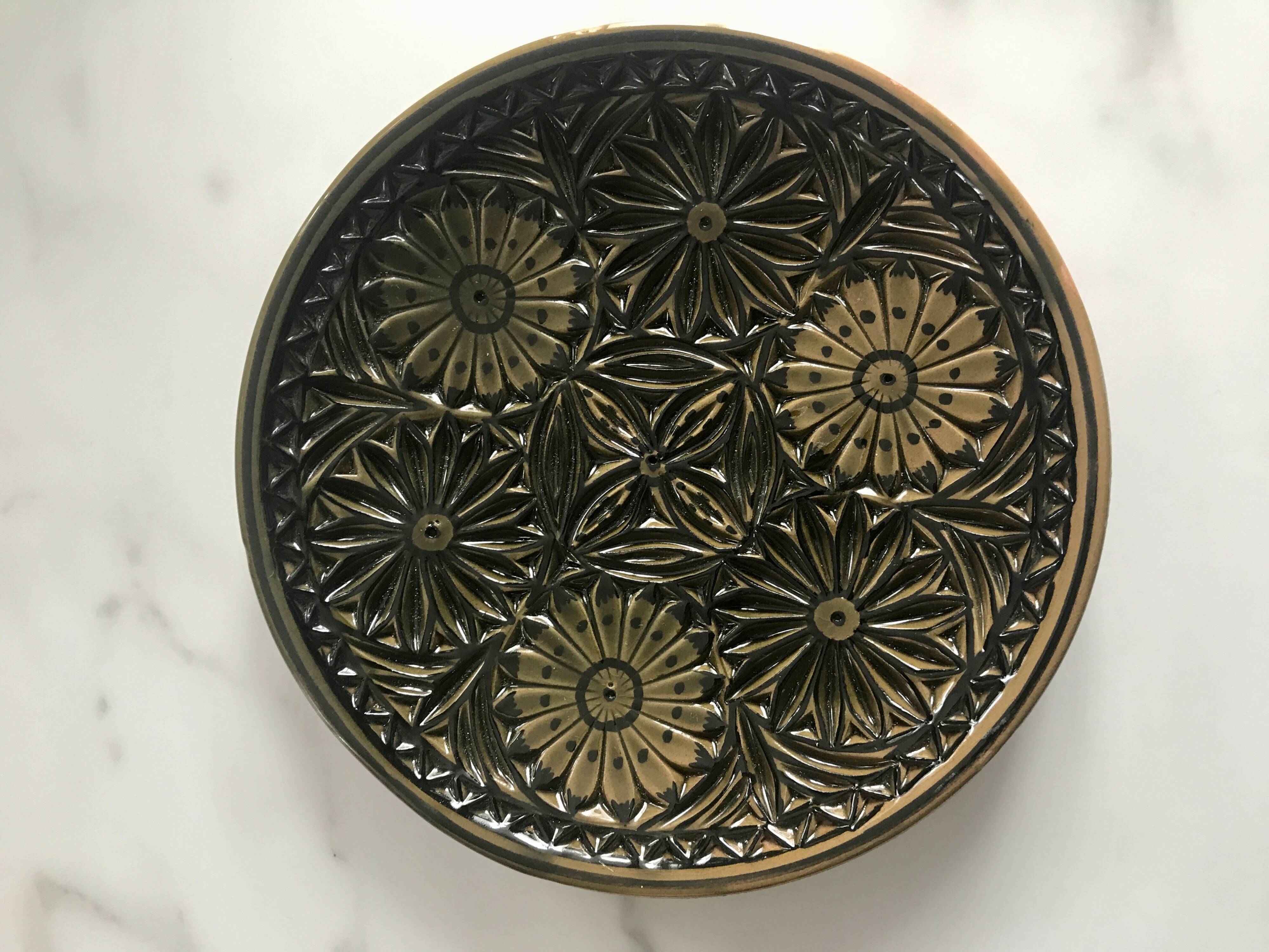 Small decorative chiseled ceramic plate