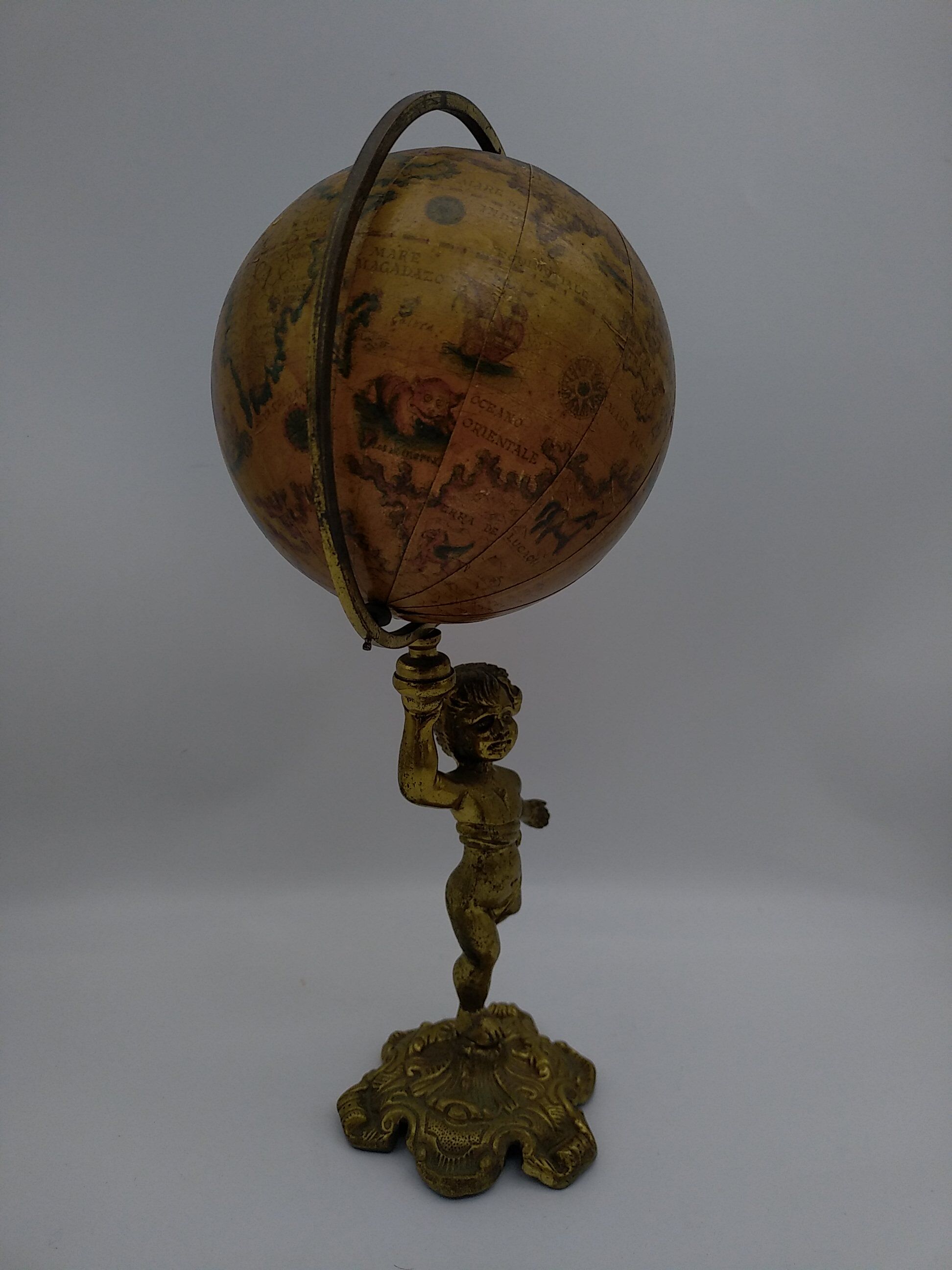 Cherub or putti carrying a globe