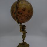 Cherub or putti carrying a globe