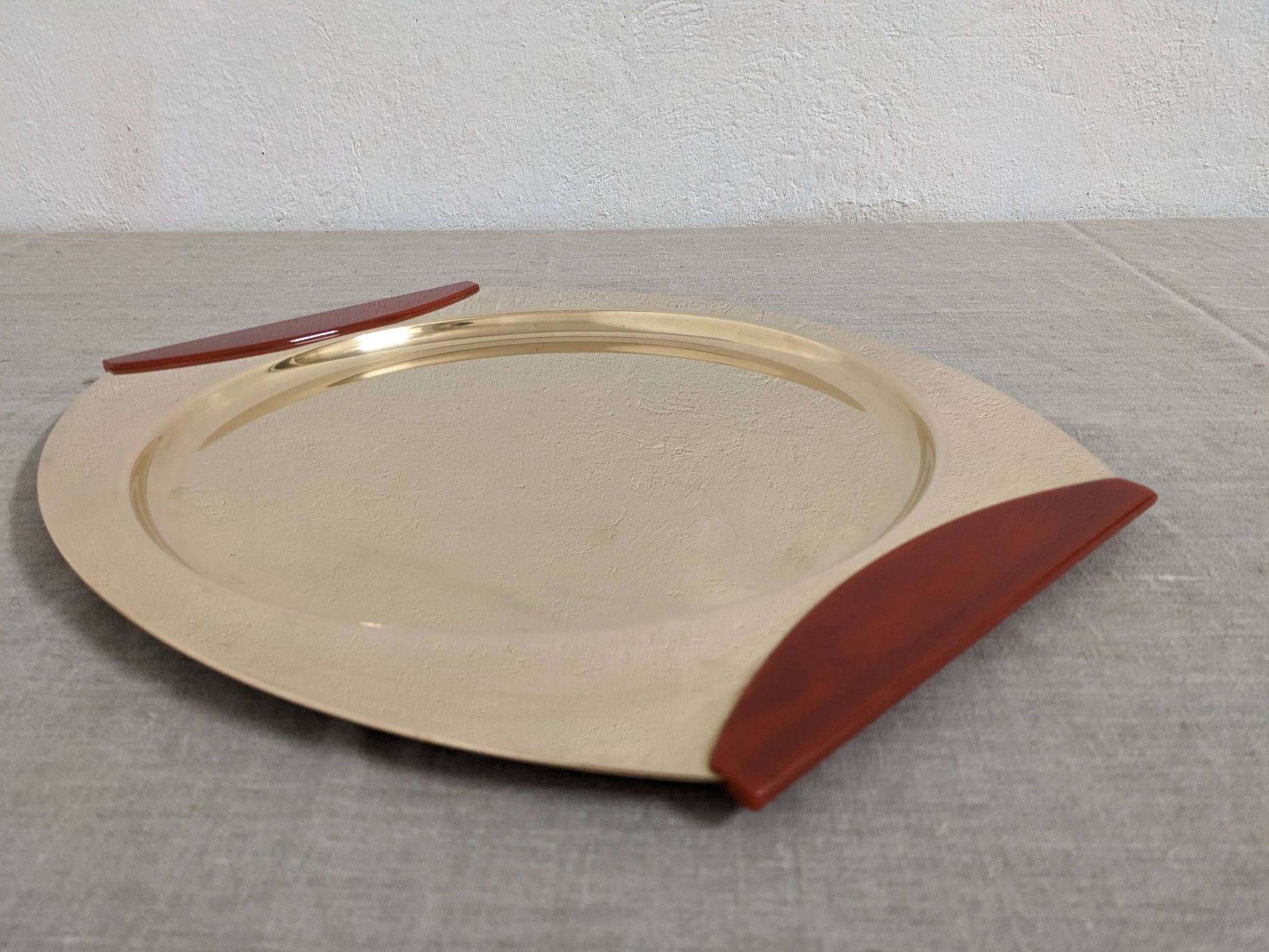 Plates and a brass and Bakelite cut by PM Italy, Italy around 1970.