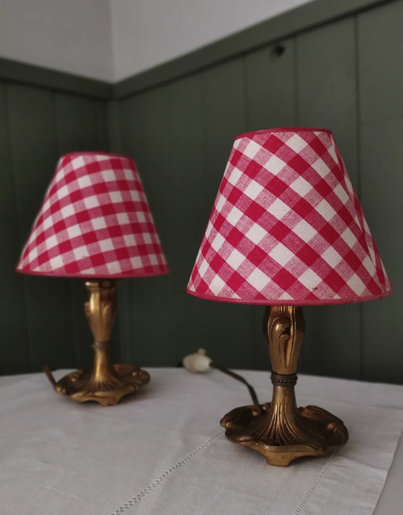 Pair of small lamps in gilded bronze by Petitot and red gingham lampshades.