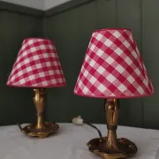 Pair of small lamps in gilded bronze by Petitot and red gingham lampshades.