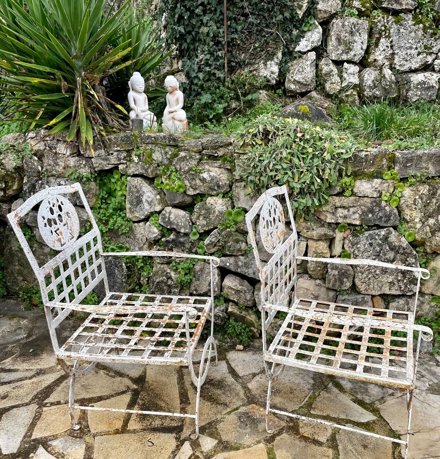Pair of wrought iron armchairs