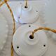 Duo of serrated opaline suspensions
