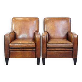 Set of 2 stylish yet comfortable armchairs made of sheepskin leather with a sleek design