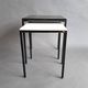 Pair of modernist nesting tables in black metal and white and black opaline 1960.