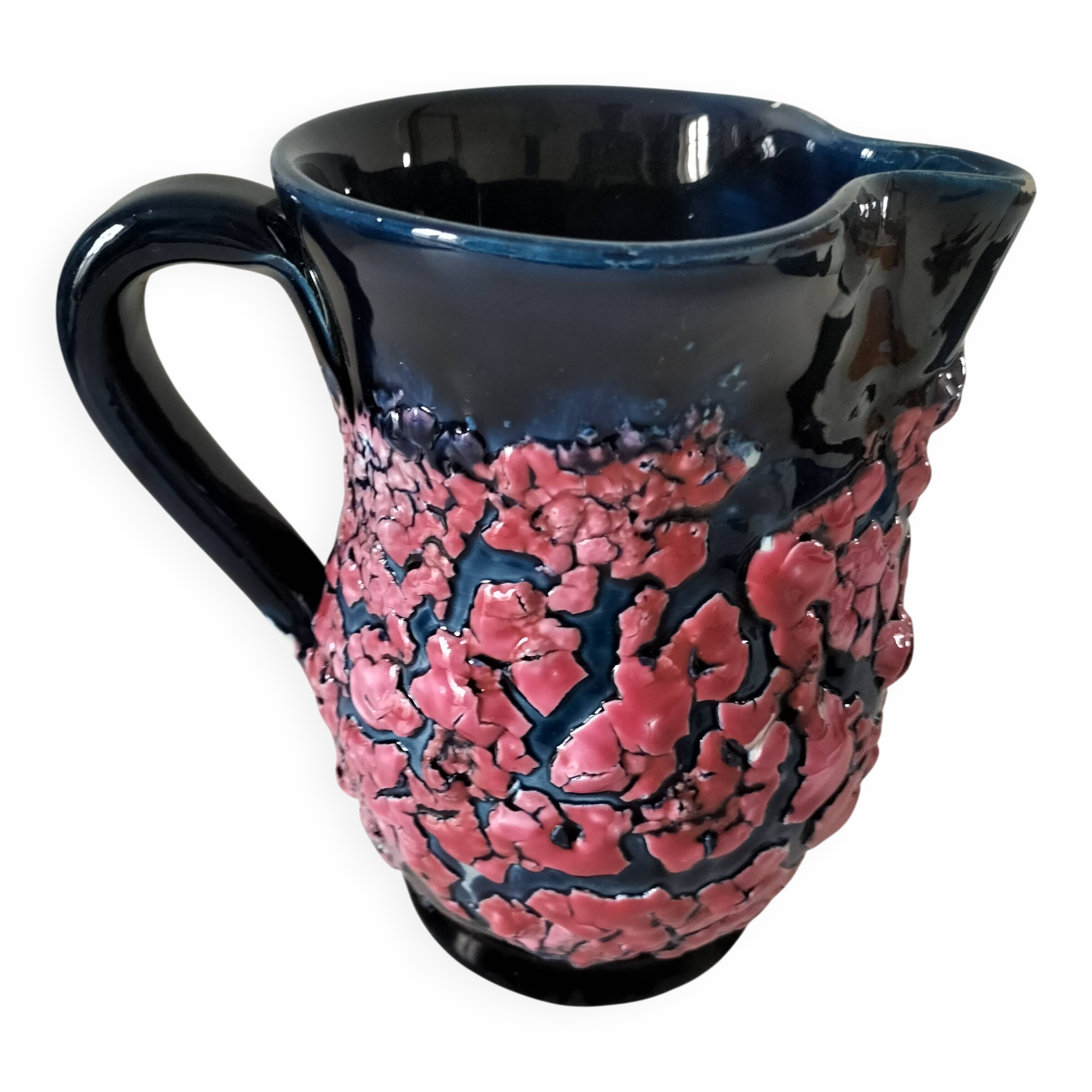 Vintage pitcher in midnight blue glazed ceramic with bright pink relief