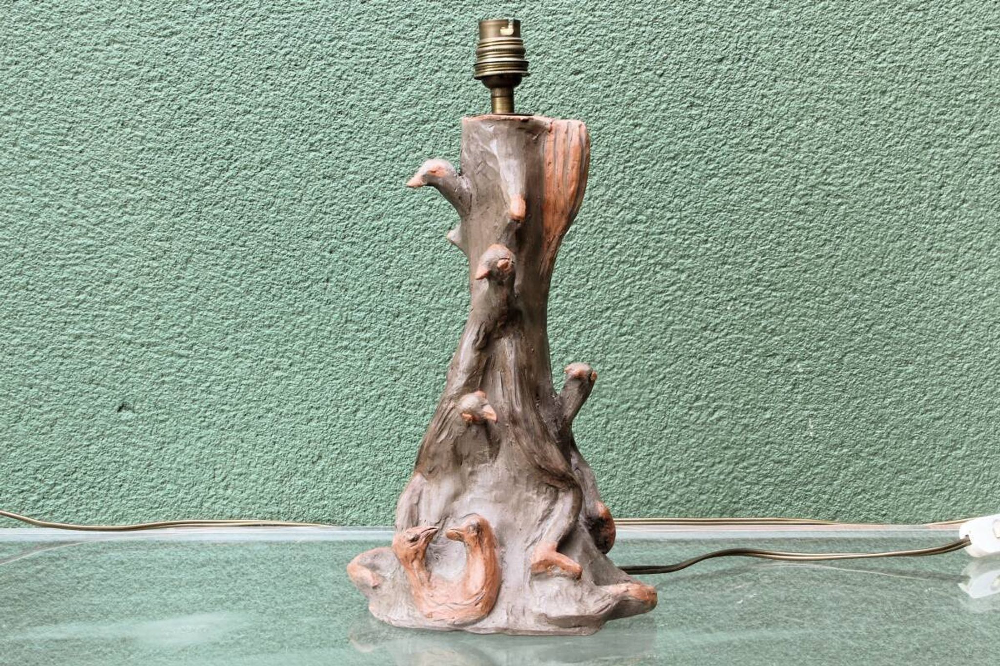 Lamp base in sculpted terracotta featuring birds, signed.