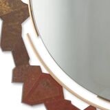 Contemporary mirror in oxidized bronze and brass with a deconstructed shape.