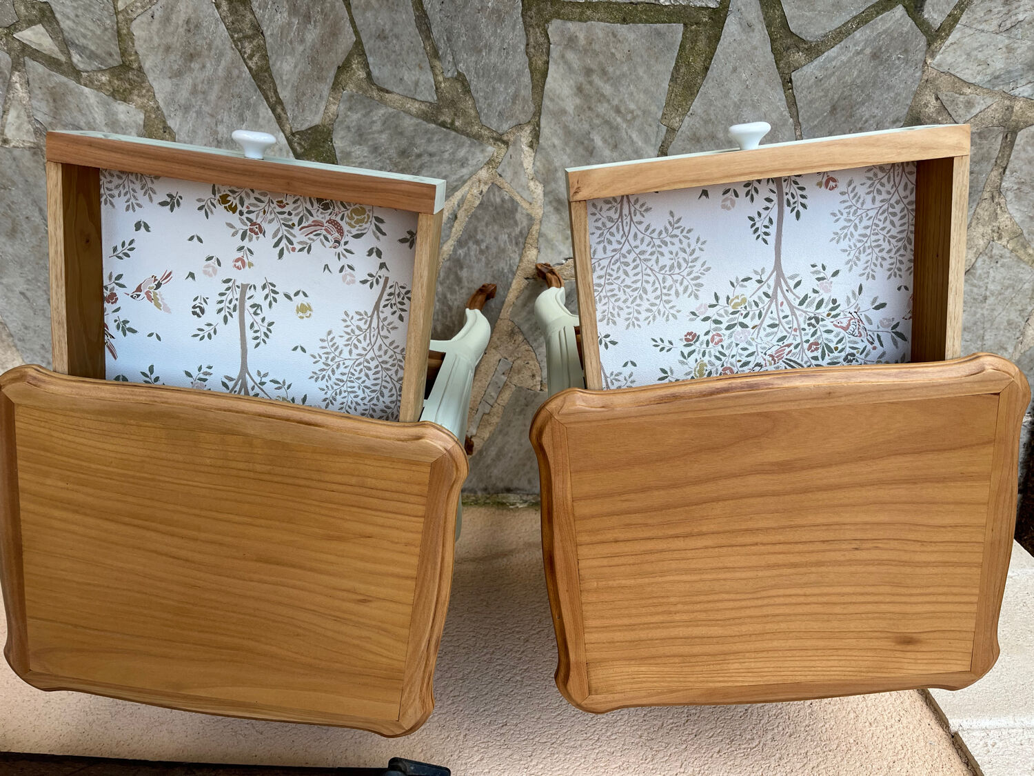 Renovated bedside tables in laurel green and light wood.