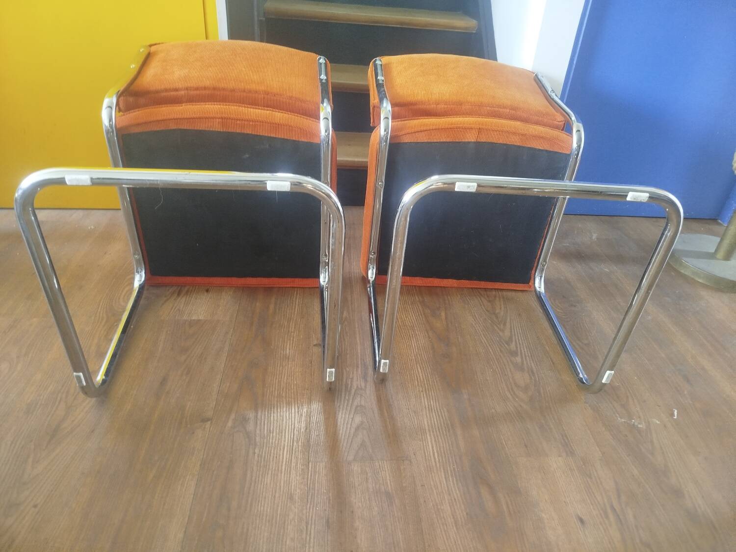 Pair of vintage cantilever chairs in chrome and orange corduroy.