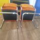 Pair of vintage cantilever chairs in chrome and orange corduroy.