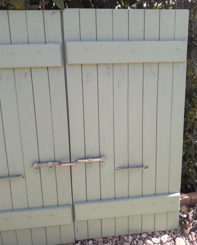 Pair of wooden shutters hanging iron