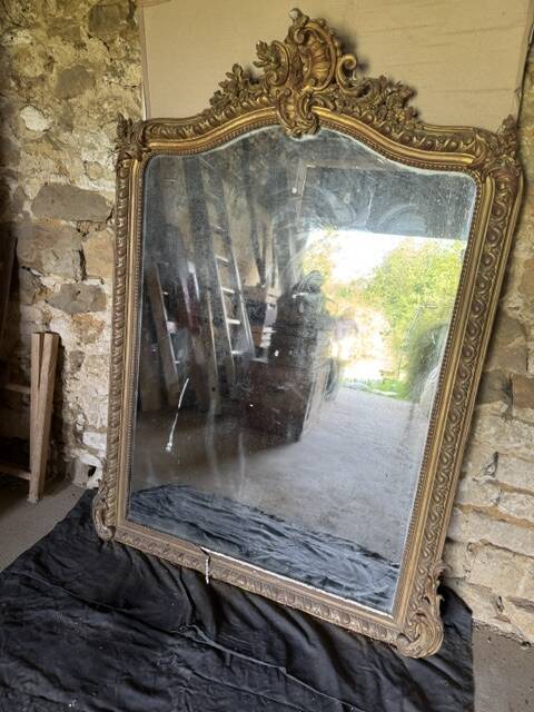Large antique mirror in wood and gilded stucco.