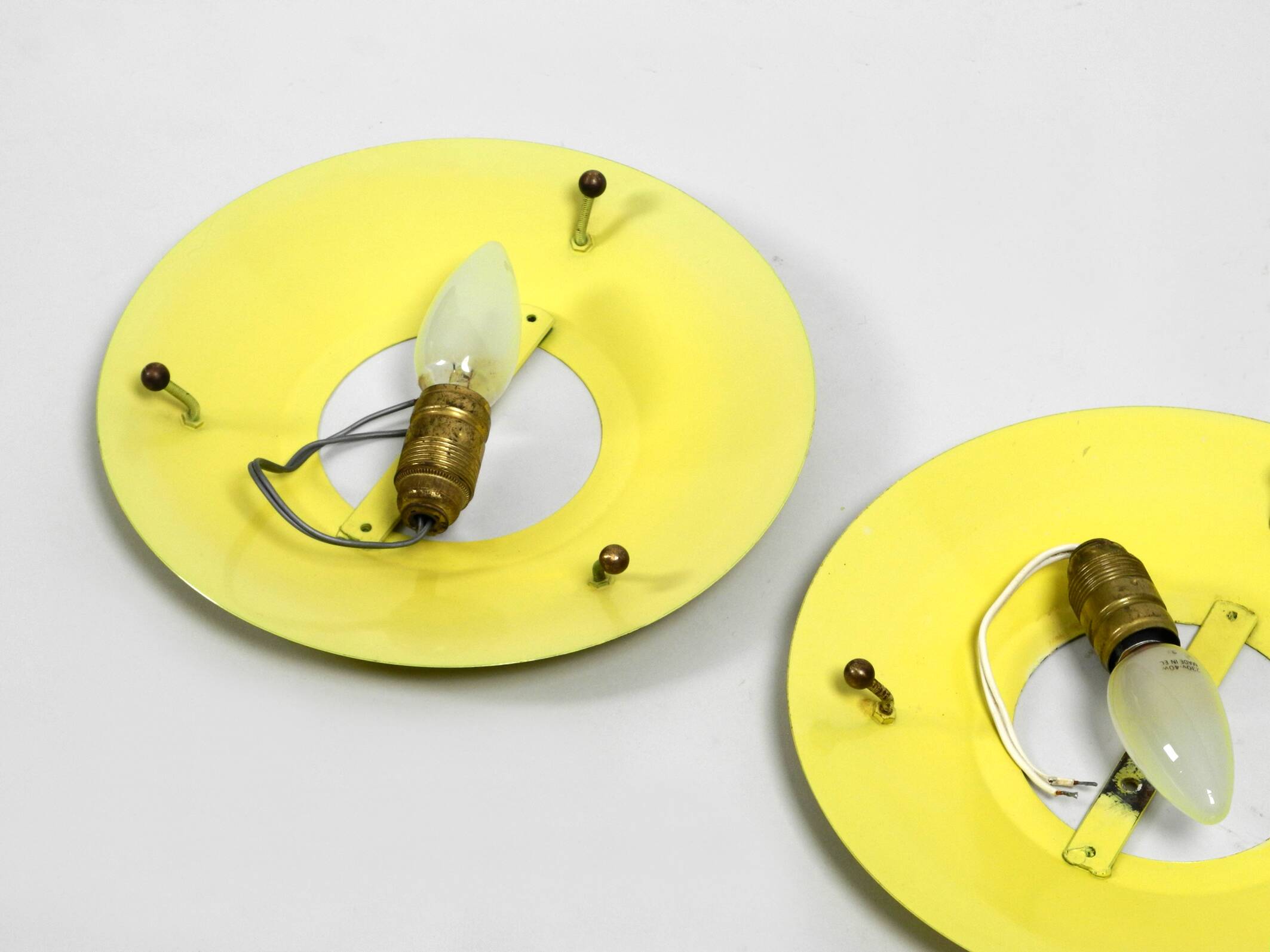 Three round 1950s wall or ceiling lamps made of metal and plexiglass shades