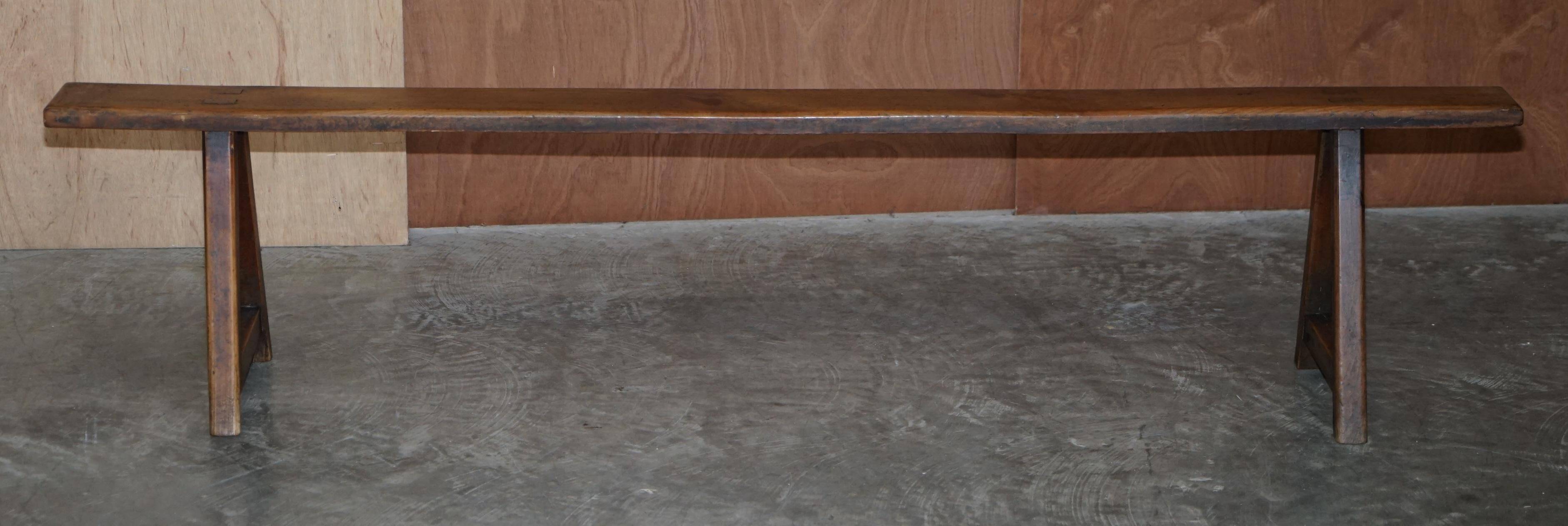 Pair of antique Victorian trestle benches in fruitwood.