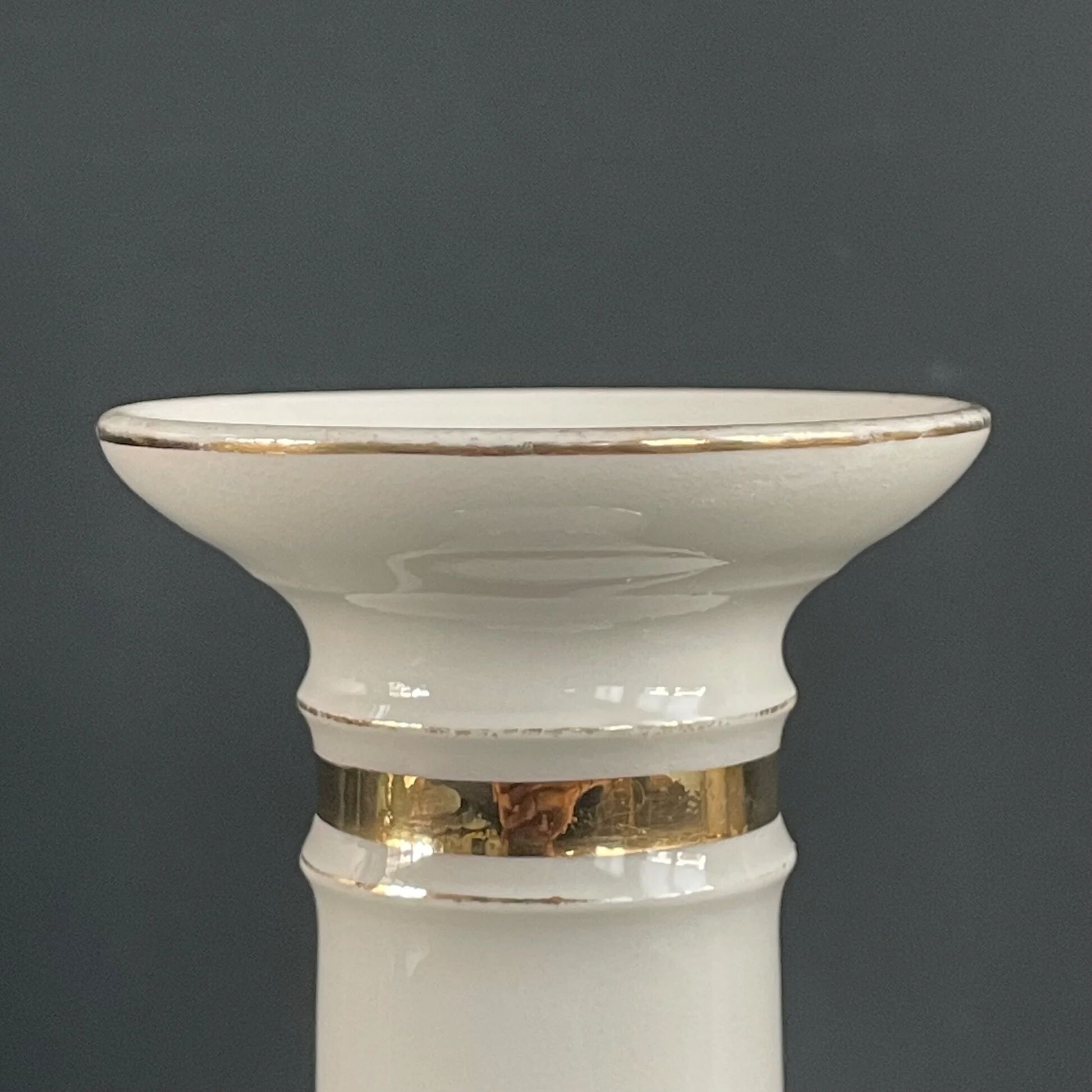 Pair of porcelain candlesticks with a gold pattern.