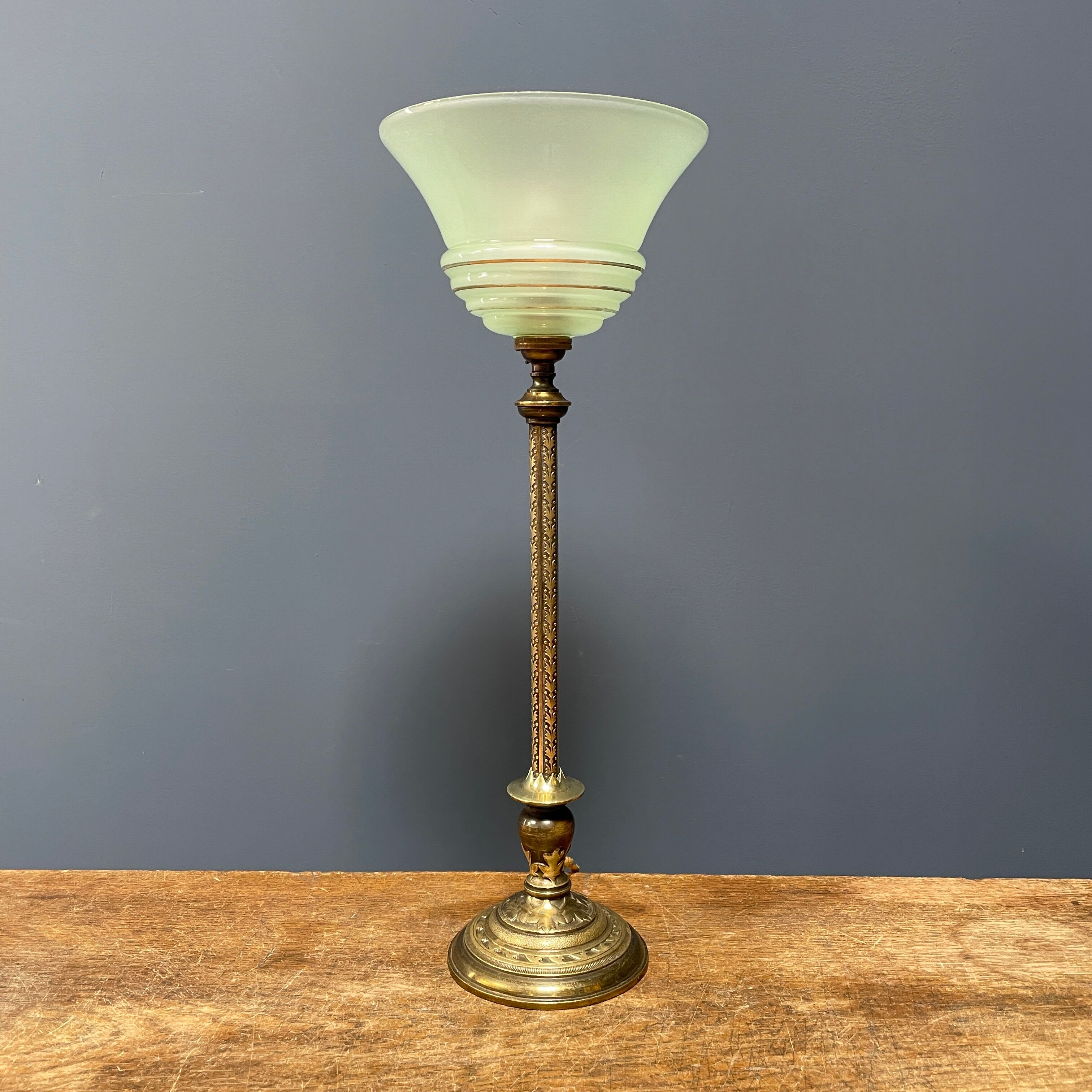 Ornate brass table lamp with mint green glass shade