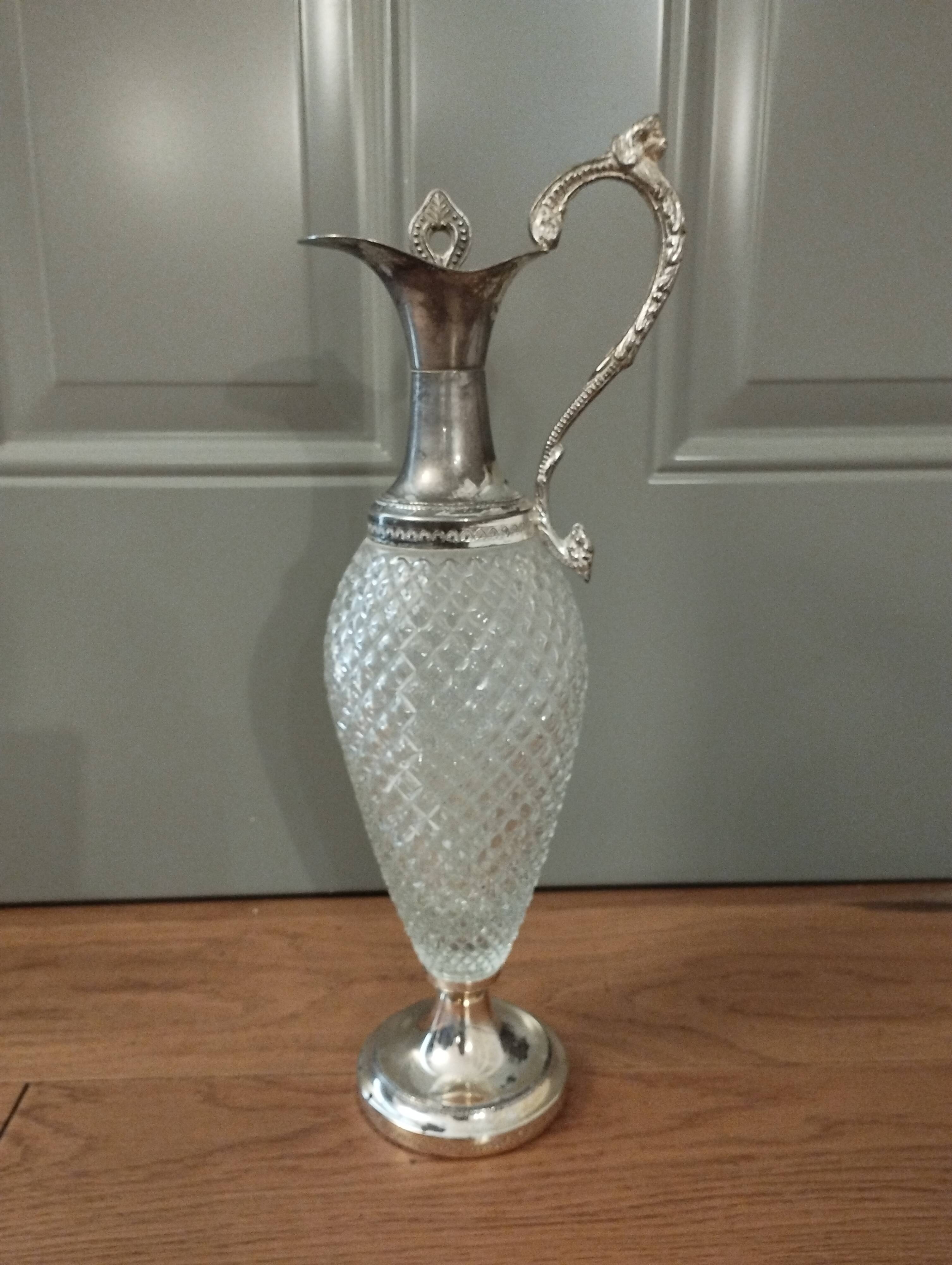 Old ewer in crystal and silver metal