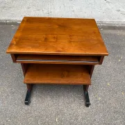 Small Scandinavian-style computer desk on wheels made of wood.