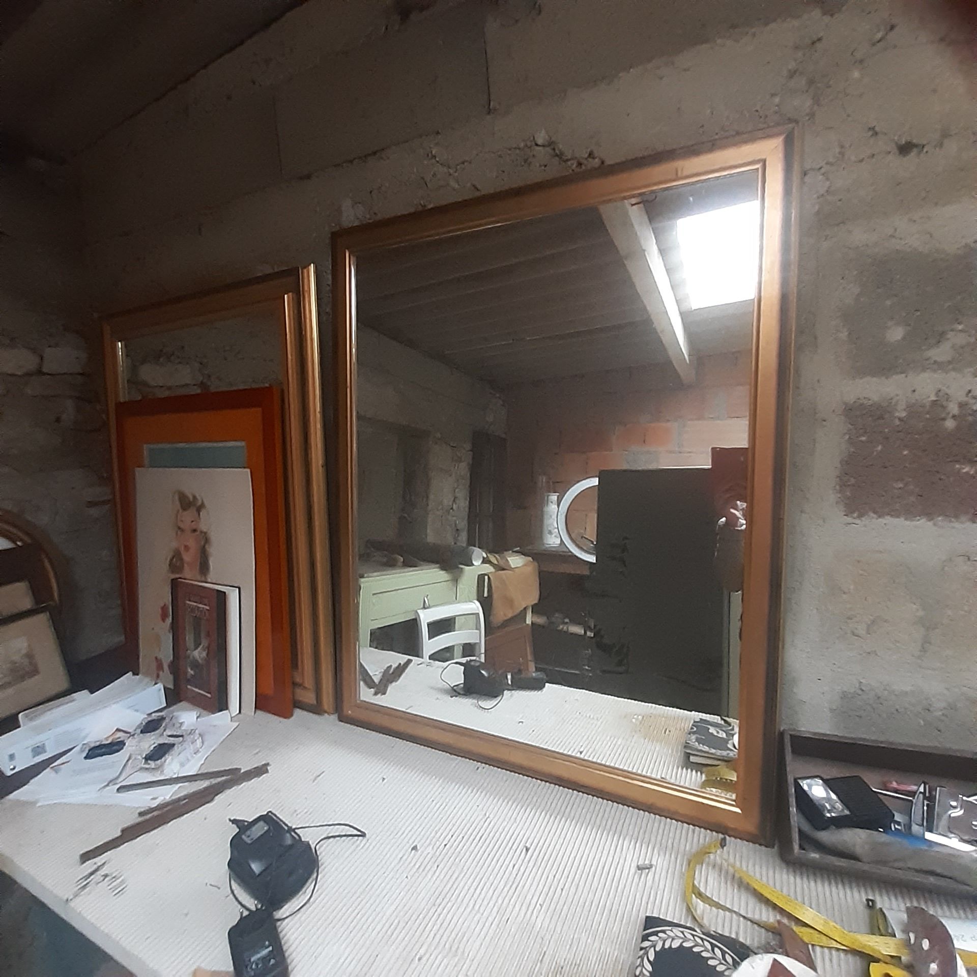 Old mirror of period handmade by cabinetmaking and decorated with gold leaf