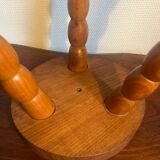 Round tripod stool in carved wood