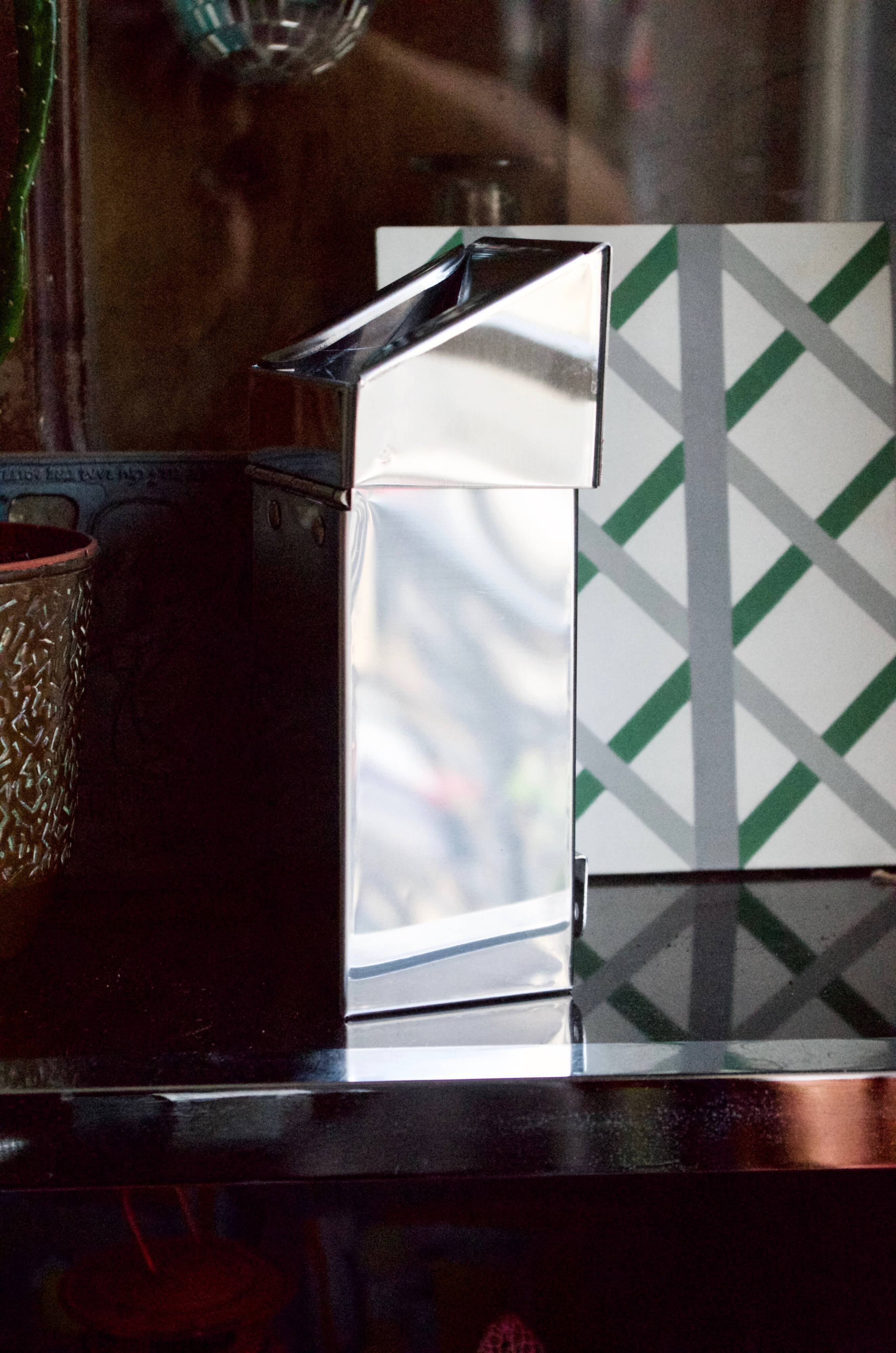 Vintage wall ashtray in shiny metal industrial style